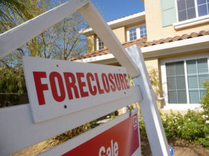 foreclosure-realestate Foreclosure sign in front of house